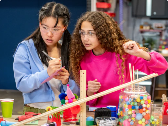 Photo of Two Young Women Doing Science Experiments