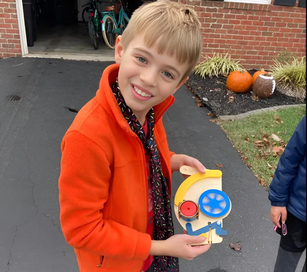 Photo of a Boy Showing Off his Build Box